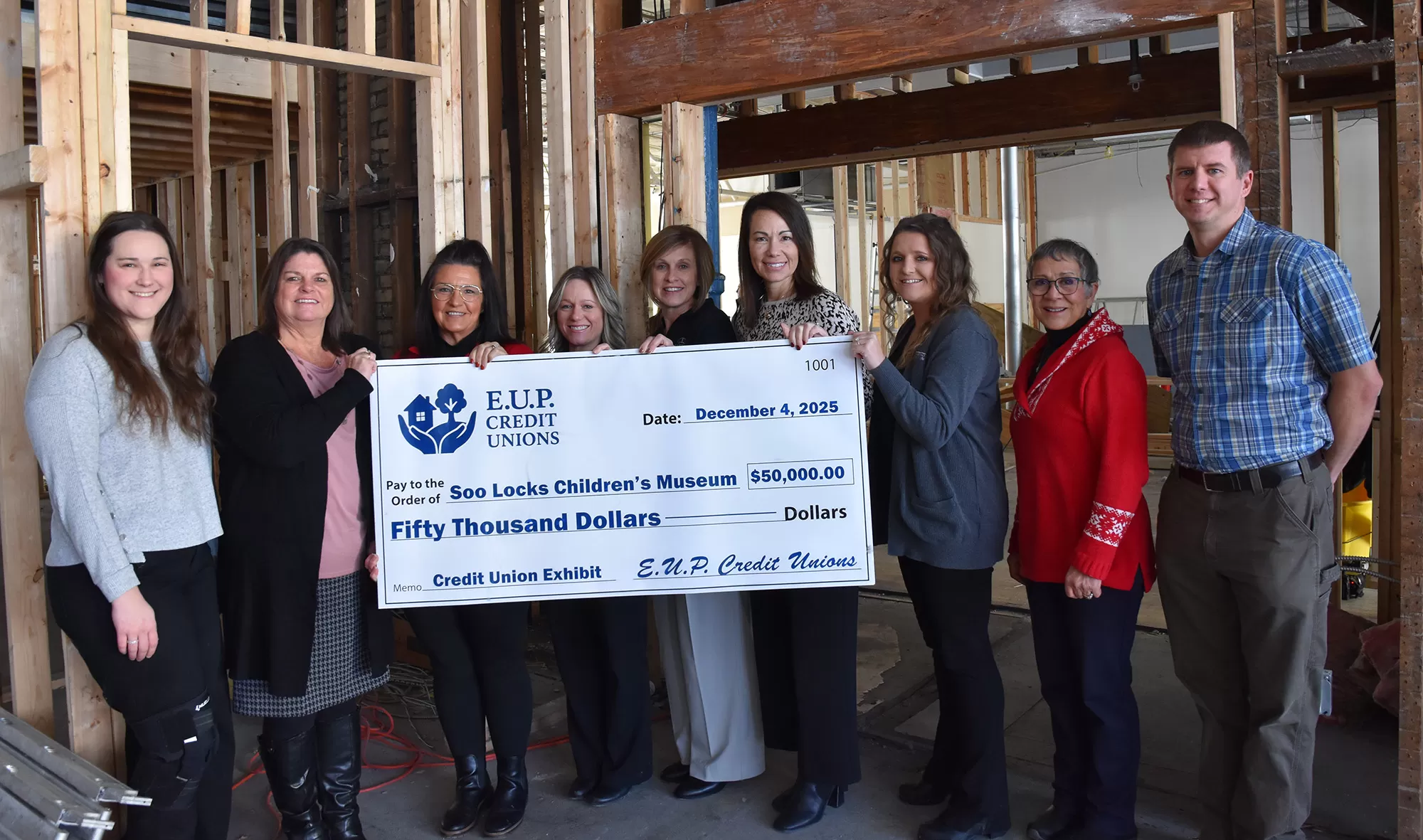 Credit Union Officials holding a check